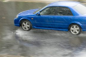 blue car sliding in the rain