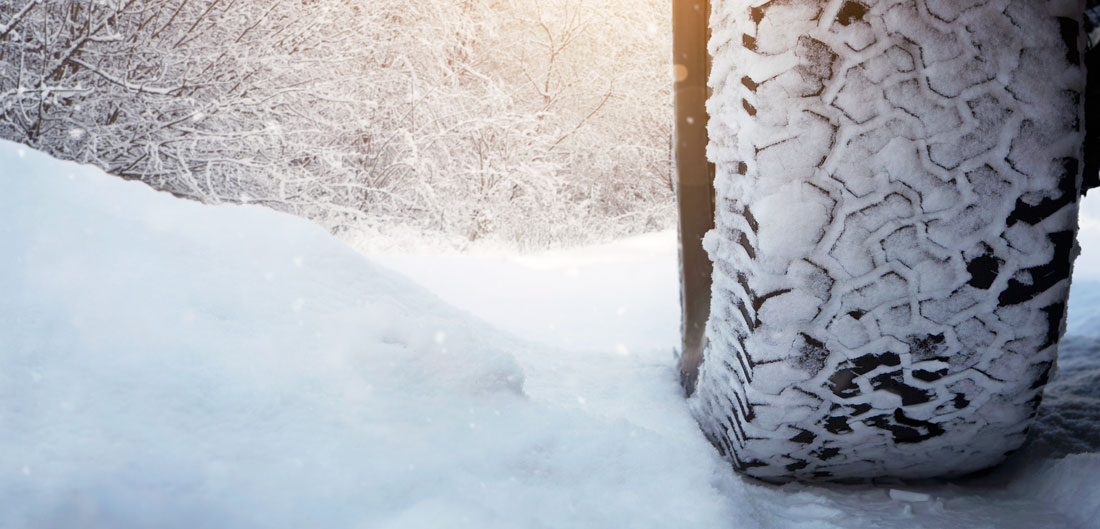 snow-covered tire drives over snow