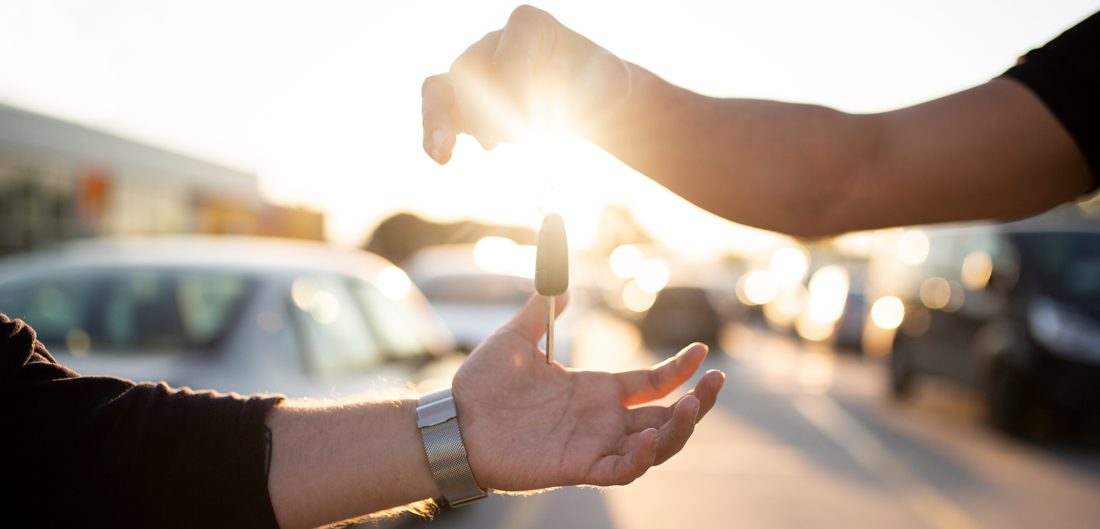 a hand holding a car key